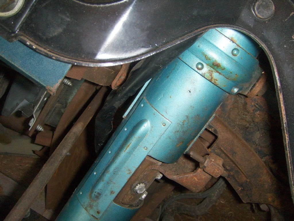 Here's a view underneath. The rusty arm bolted to the shift tube is the mechanism for swinging the wheel away. I had to see it in action to visualize how it all worked.