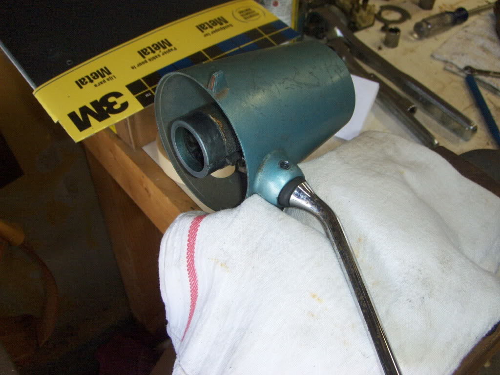 The shifter arm is resting on a vice under the towel. A few swift strokes of a hammer, and the pin came out. It should be noted that even with the towel, there was some damage to the collar.