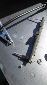 Permanently adding a spacer and bolts to the driver's side seat brackets.
